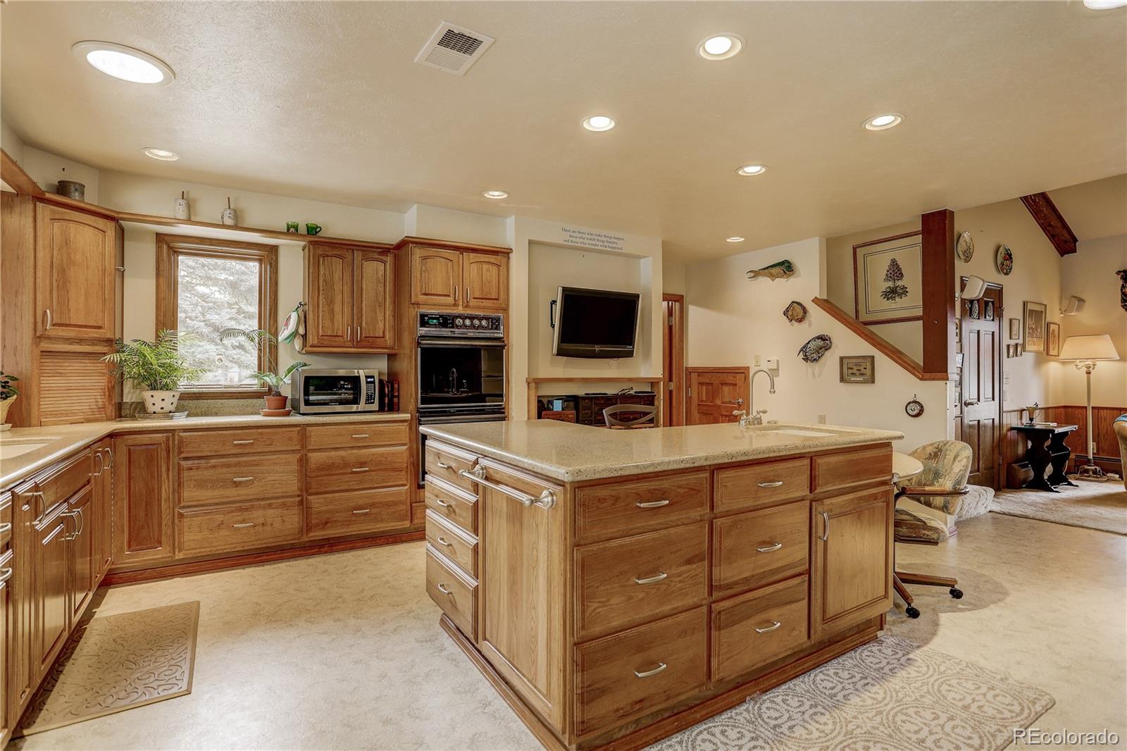 1310 Old Tale Road Boulder, CO 80303 - Photo 8 of 23 a kitchen that has a lot of cabinets in it and wooden floors