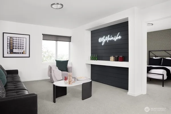 a bedroom with a bed a couch and a large window