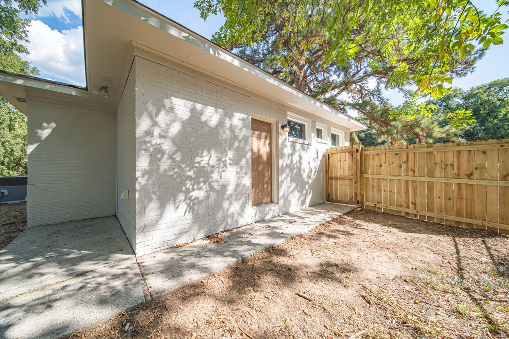 3009 Plantation Road Columbus, GA 31903 - Photo 3 of 13 a view of a yard with wooden fence