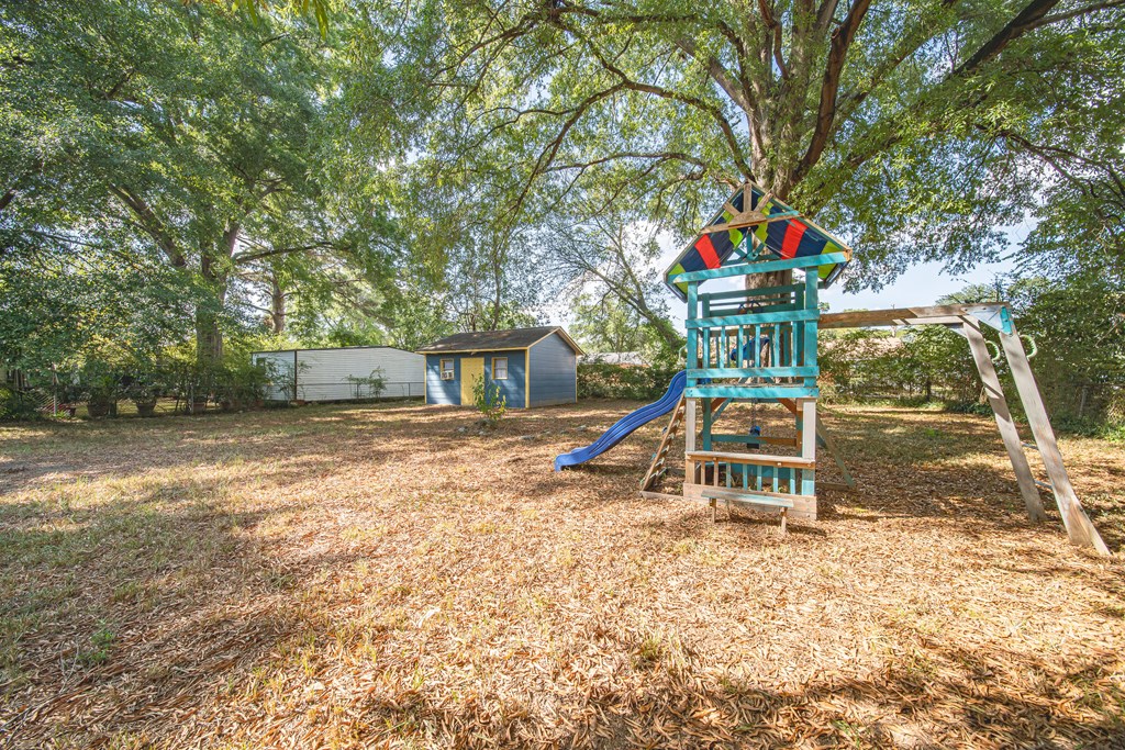 3009 Plantation Road Columbus, GA 31903 - Photo 4 of 13 a small hurt is sitting in the middle of a yard