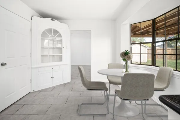 a view of a dining room with furniture and windows