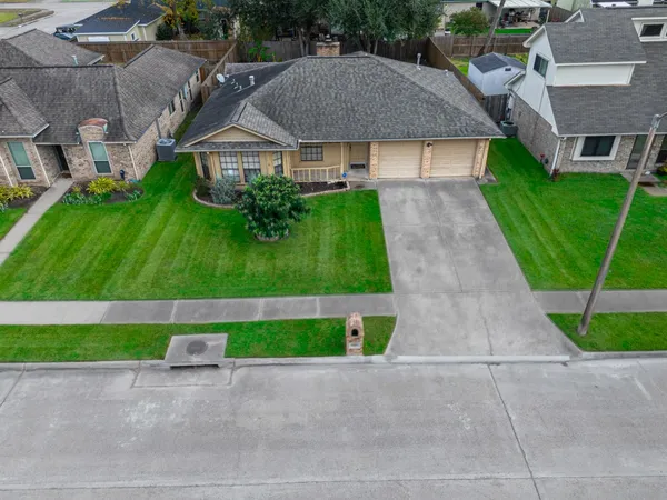 a aerial view of a house with a yard and garage