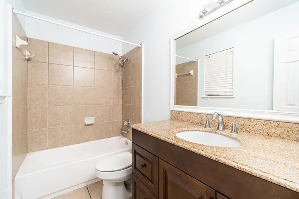 a spacious bedroom with a bed and large windows