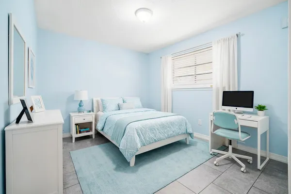 a bedroom with a bed and a desk