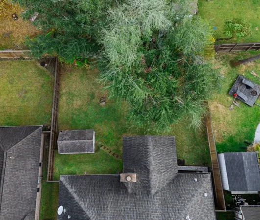 an aerial view of a house with garden space and street view