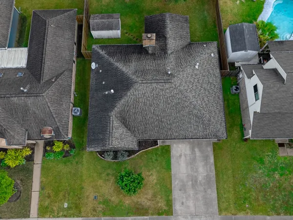 an aerial view of a house with a yard
