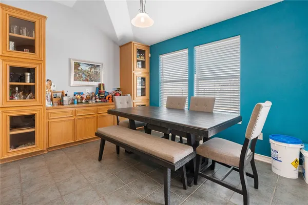 a kitchen with a table chairs and a stove