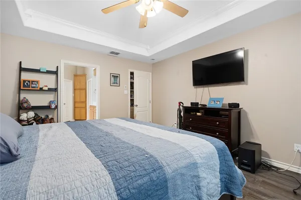 a bedroom with a bed and a flat screen tv