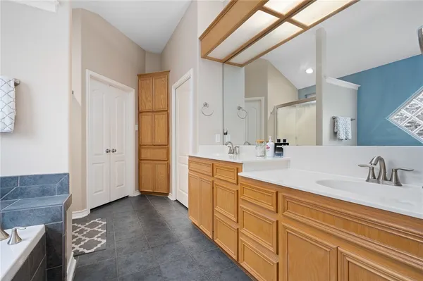a spacious bathroom with double sink and a mirror