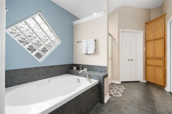 a bathroom with a bathtub and a window