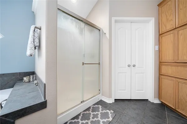 a view of bathroom with a shower and a sink