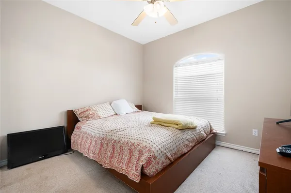 a bedroom with a bed and window