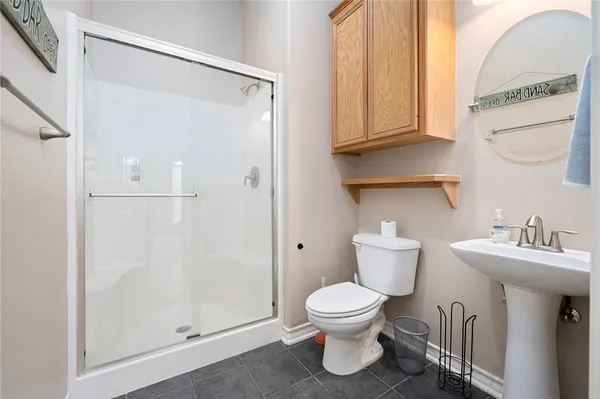a bathroom with a toilet sink and shower