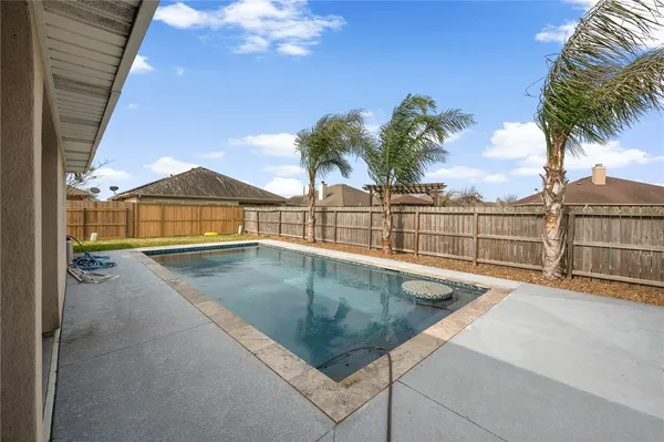 a view of a patio with a table and chairs