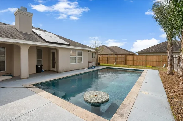 a view of swimming pool with outdoor seating and a patio