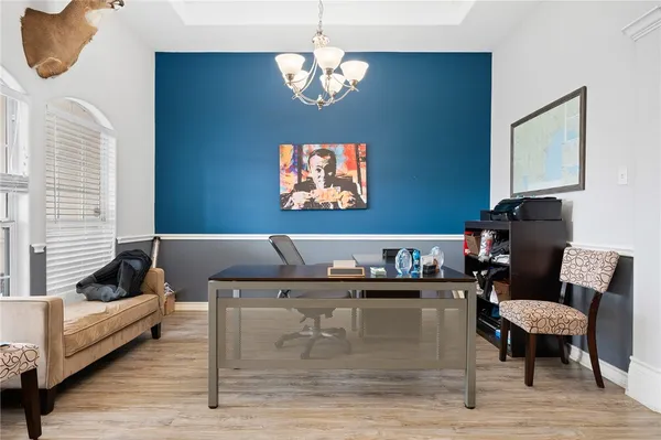 a living room with furniture and a chandelier