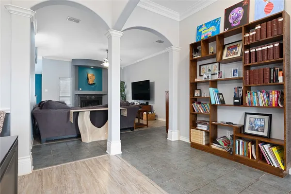 a living room with a couch and a book shelf