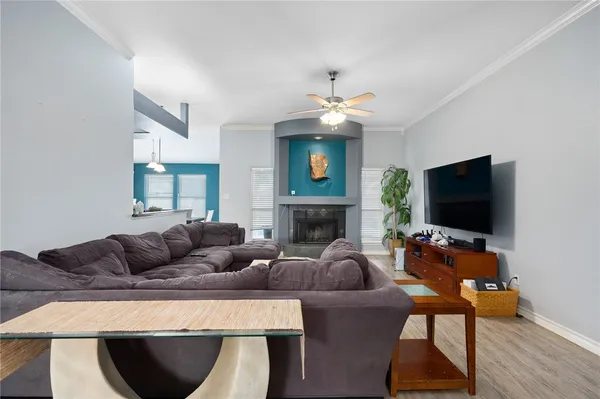 a living room with furniture a flat screen tv and a fireplace