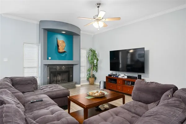 a living room with furniture a flat screen tv and a fireplace
