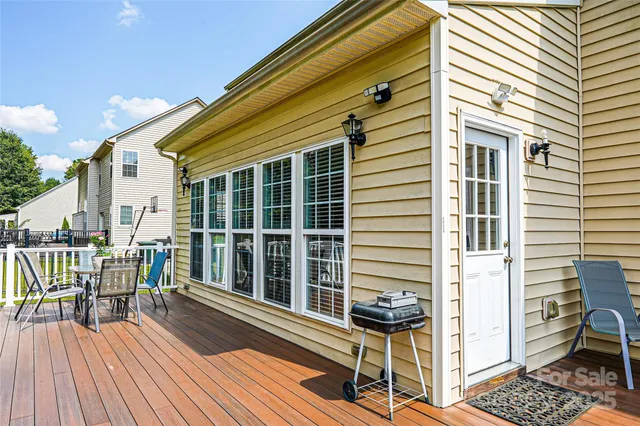 a view of a balcony with chairs and wooden floor