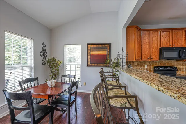 a dining room with furniture windows and a flat screen tv