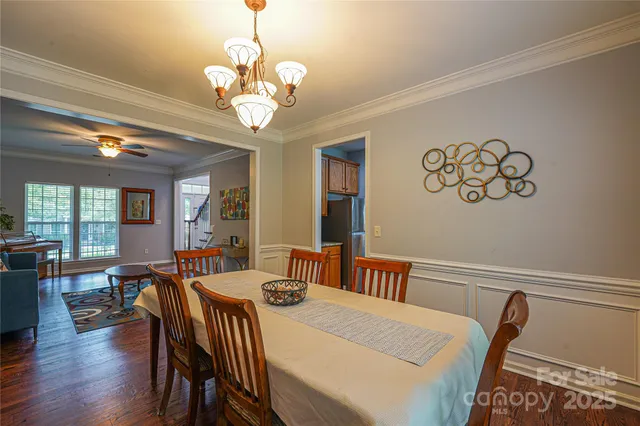a view of a dining room with furniture wooden floor and chandelier