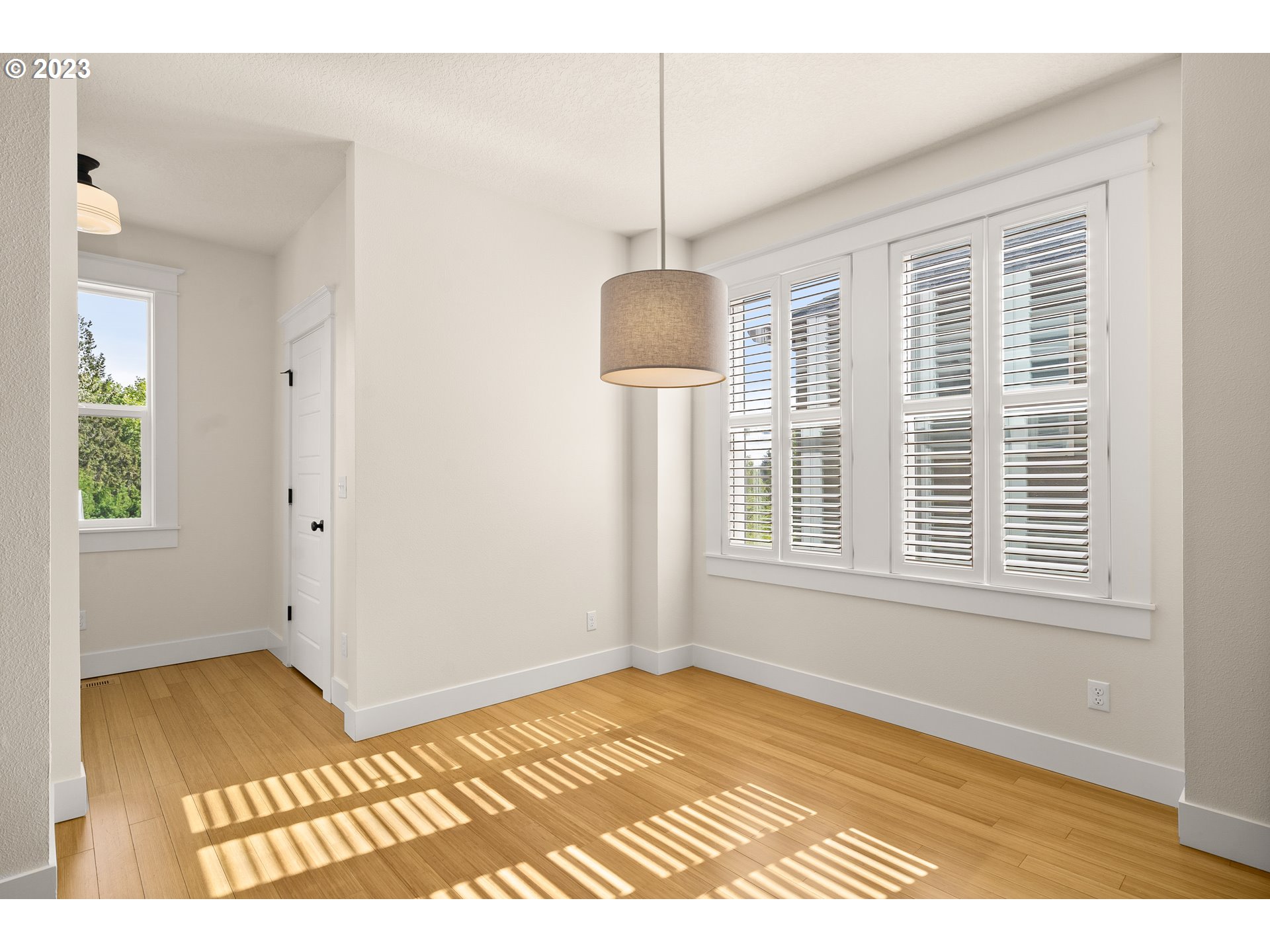 3917 Southwest Stephenson Street Portland, OR 97219 - Photo 16 of 34 a view of an empty room with wooden floor and a window