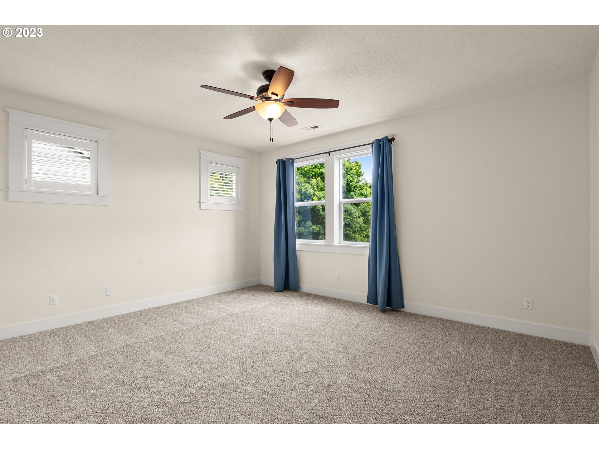 3917 Southwest Stephenson Street Portland, OR 97219 - Photo 20 of 34 a view of a big room with a ceiling fan and windows