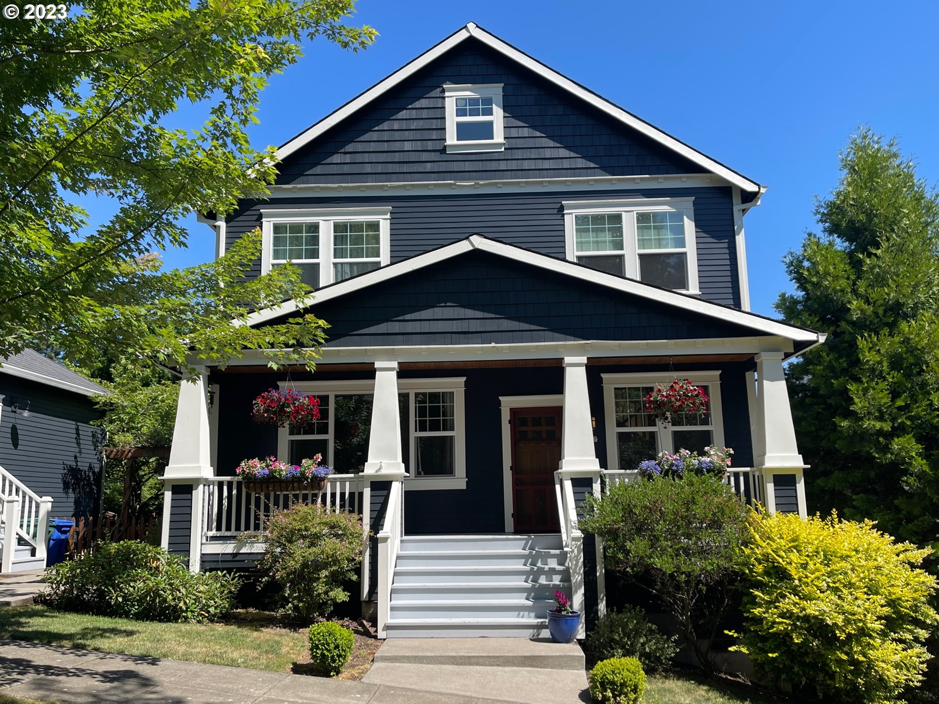 3917 Southwest Stephenson Street Portland, OR 97219 - Photo 2 of 34 a front view of a house with a yard