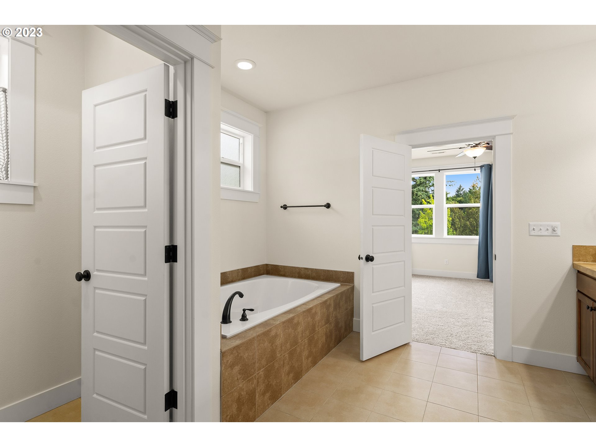 3917 Southwest Stephenson Street Portland, OR 97219 - Photo 22 of 34 a bathroom with a bathtub and a sink