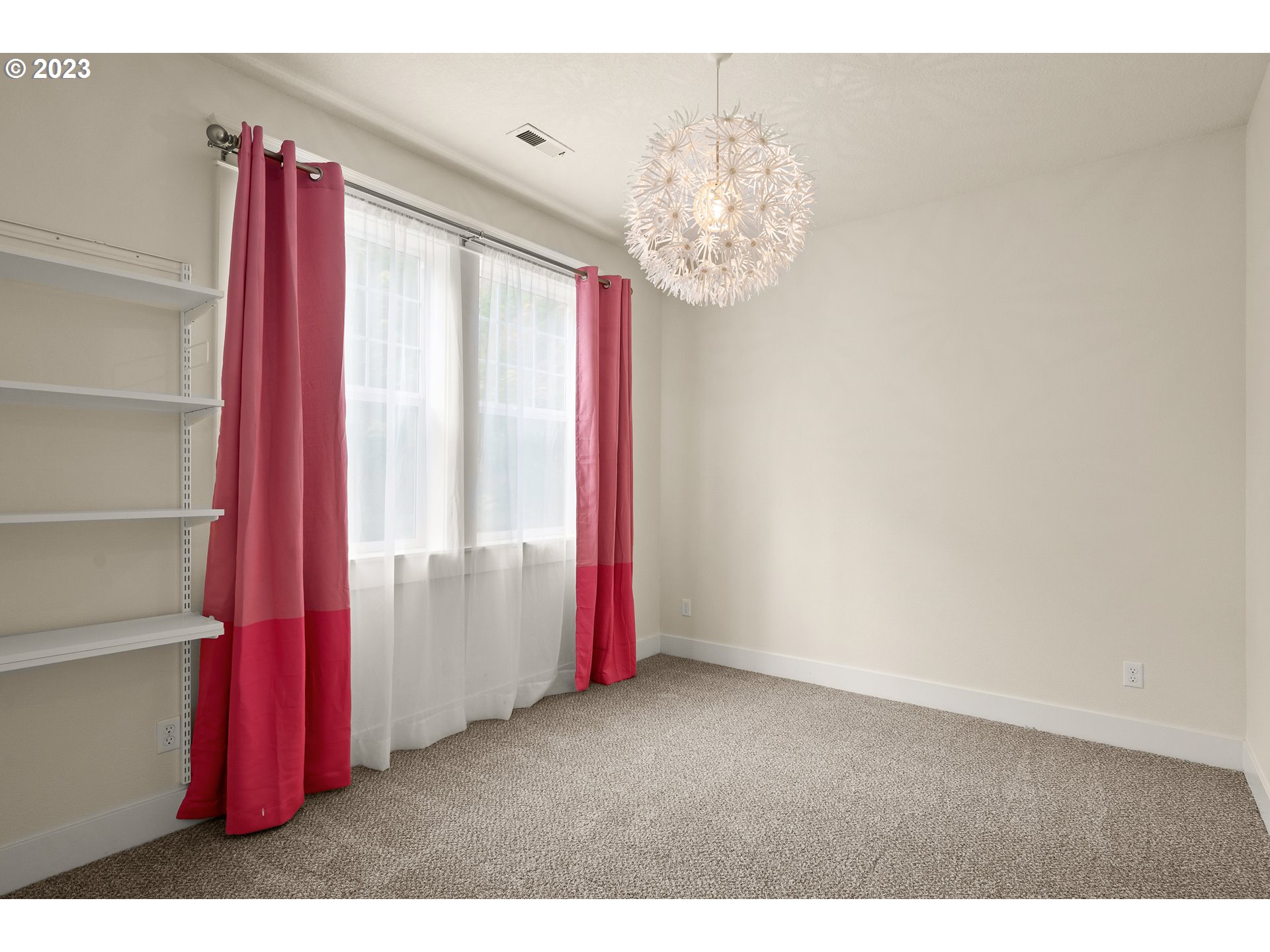 3917 Southwest Stephenson Street Portland, OR 97219 - Photo 24 of 34 a view of a room with a chandelier and a large window