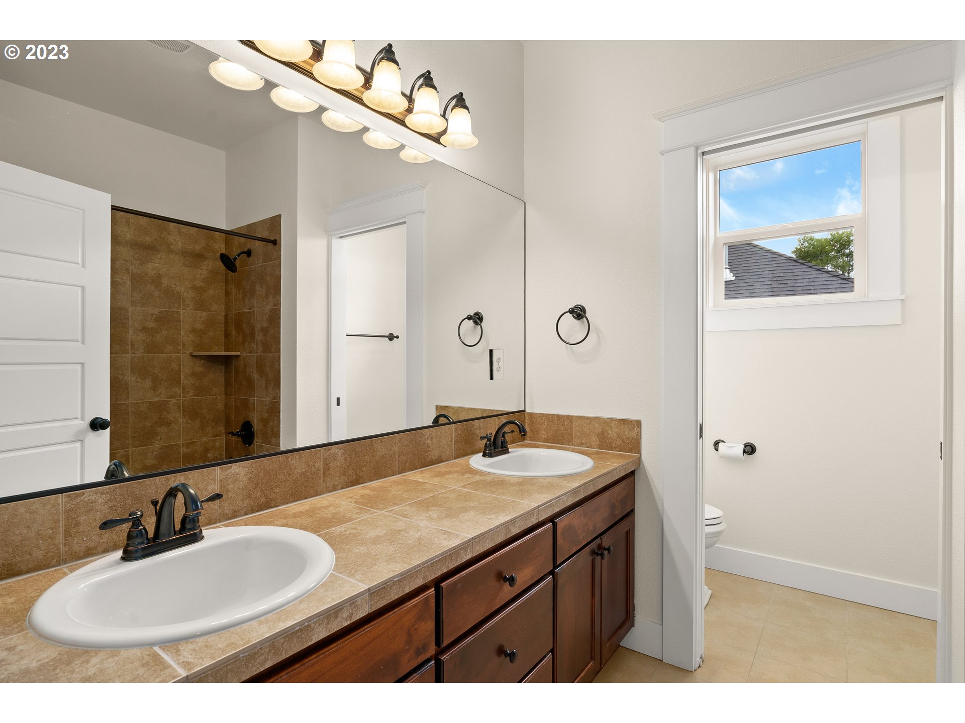 3917 Southwest Stephenson Street Portland, OR 97219 - Photo 26 of 34 a bathroom with a sink a vanity and a mirror