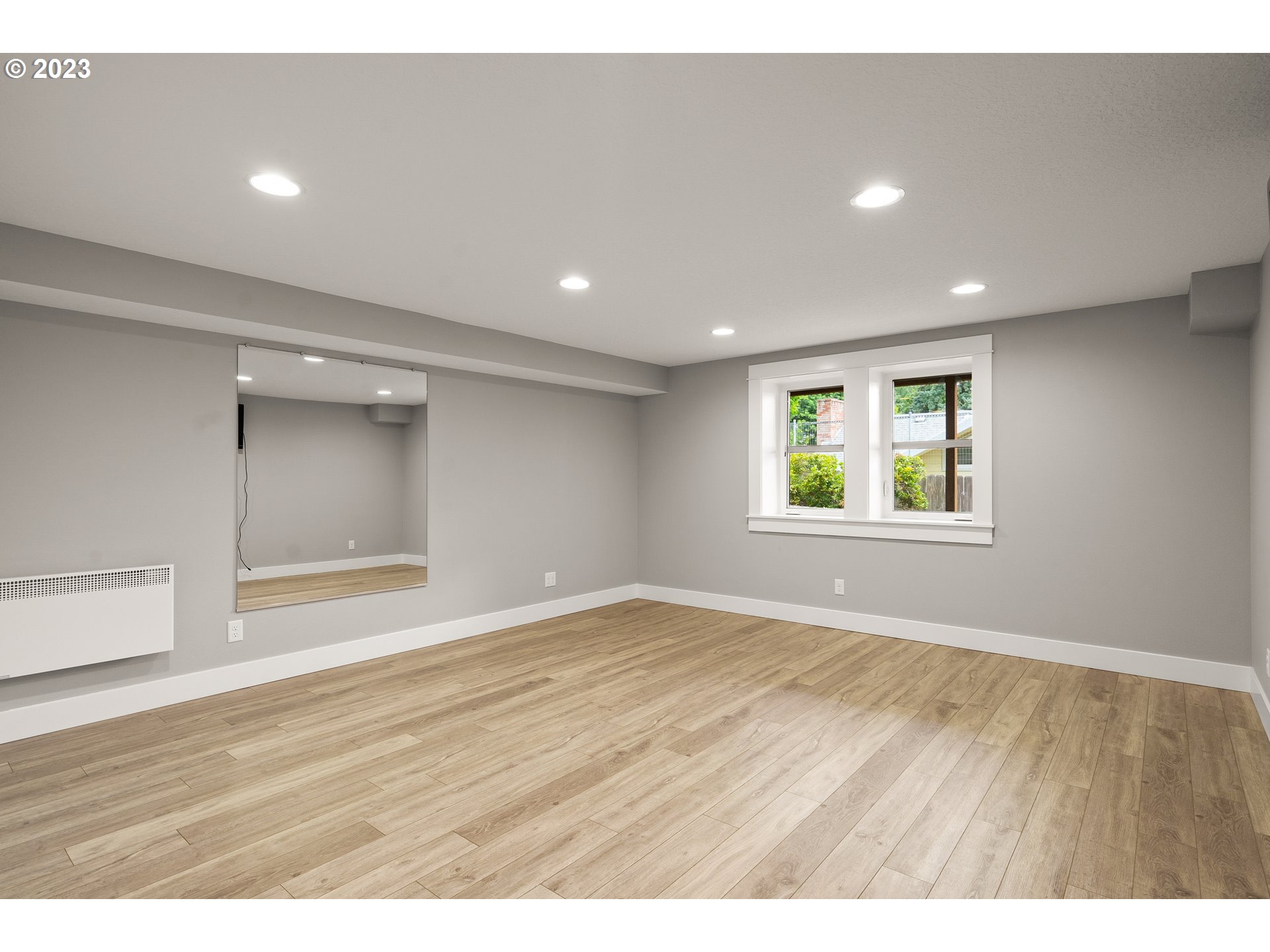 3917 Southwest Stephenson Street Portland, OR 97219 - Photo 31 of 34 an empty room with wooden floor and windows