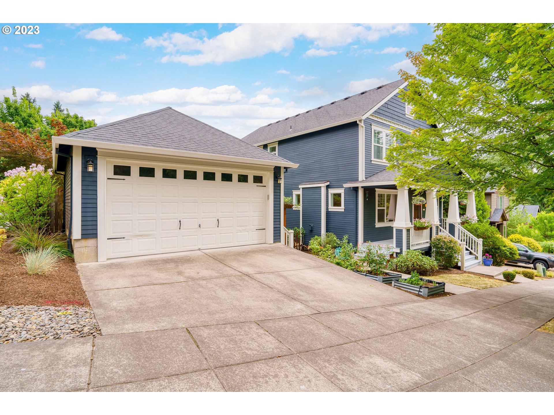 3917 Southwest Stephenson Street Portland, OR 97219 - Photo 4 of 34 a front view of a house with a yard and garage