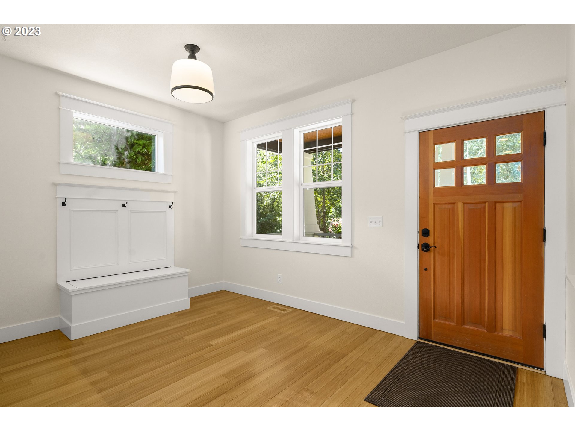 3917 Southwest Stephenson Street Portland, OR 97219 - Photo 6 of 34 a view of an empty room with wooden floor and a window