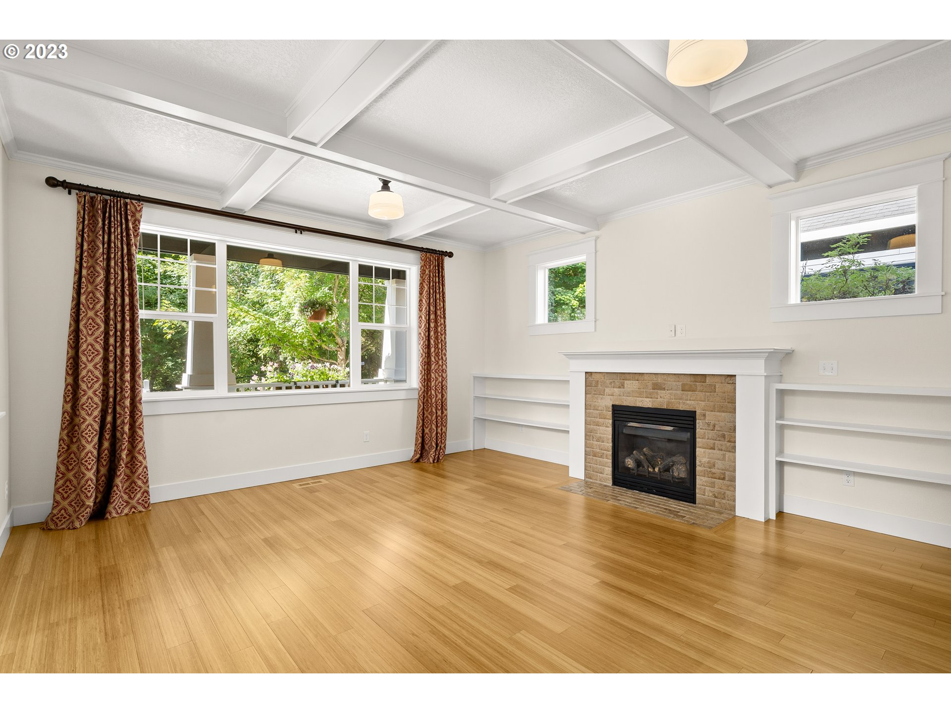 3917 Southwest Stephenson Street Portland, OR 97219 - Photo 8 of 34 a view of empty room with a fireplace and wooden floor