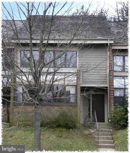 10999 Thrush Ridge Road Reston, VA 20191 - Photo 1 of 24 a front view of a house with a garden