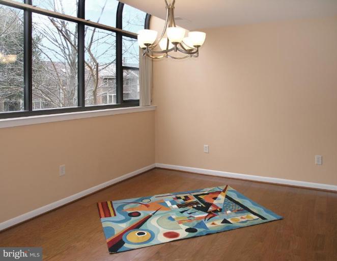 10999 Thrush Ridge Road Reston, VA 20191 - Photo 3 of 24 a view of a room with wooden floor and a chandelier