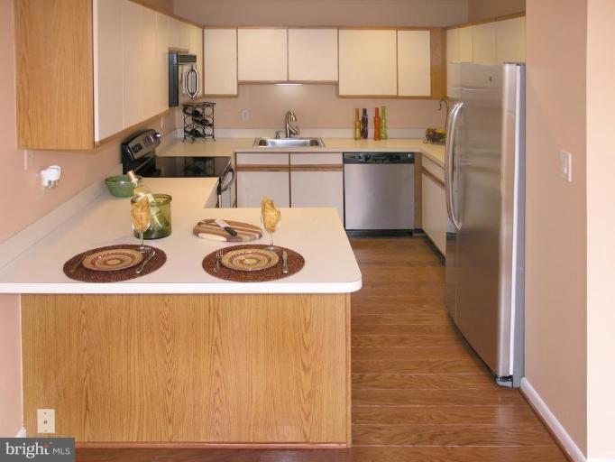 10999 Thrush Ridge Road Reston, VA 20191 - Photo 5 of 24 a kitchen with a sink a stove and refrigerator