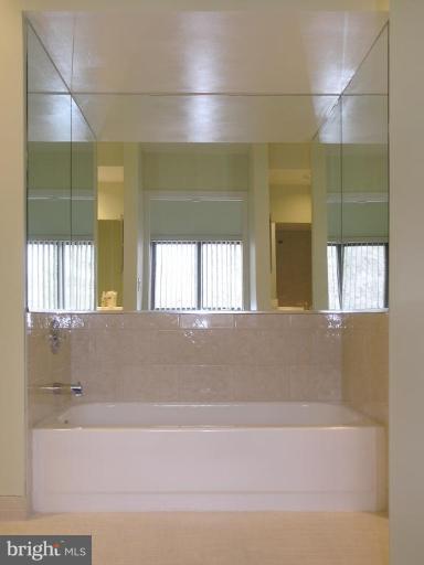 10999 Thrush Ridge Road Reston, VA 20191 - Photo 10 of 24 a bathroom with a bathtub and a shower