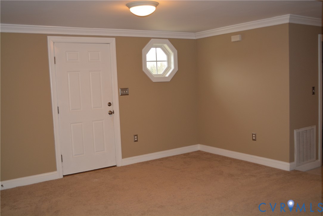 4550 Powhatan Lakes Road Powhatan, VA 23139 - Photo 3 of 17 an empty room with a window and a mirror