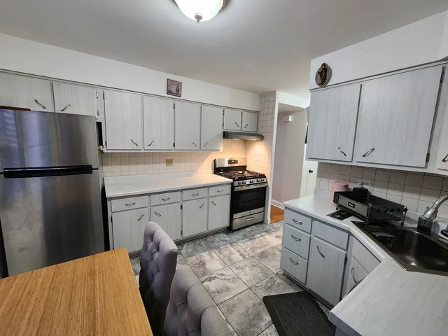 a kitchen with stainless steel appliances granite countertop a sink dishwasher stove and cabinets