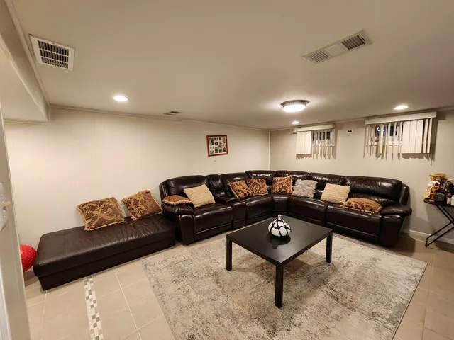 a living room with furniture and a piano