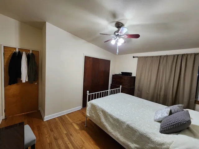 a bedroom with a bed and cabinets