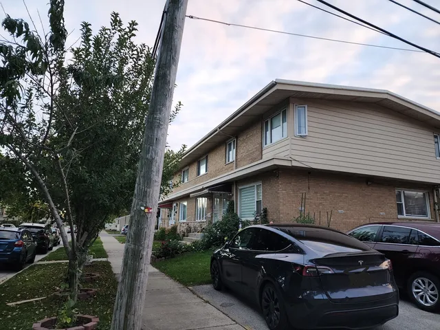a view of a car parked front of a house