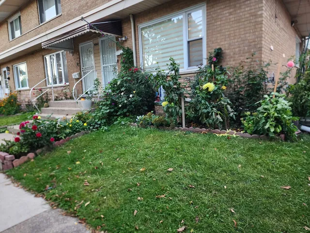 a view of a house with a garden and pathway