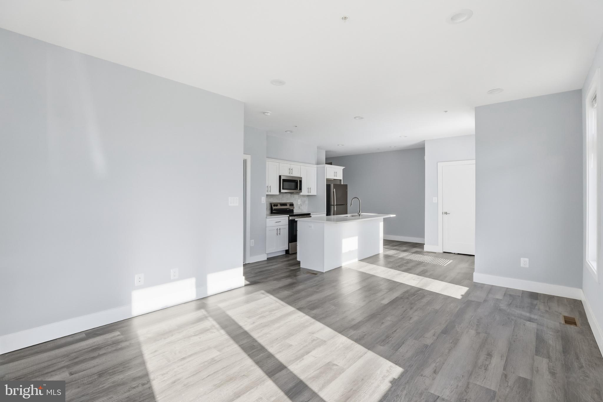 2600 4th Street Northeast, Unit A Washington, DC 20002 - Photo 12 of 33 a view of a kitchen with wooden floor and electronic appliances