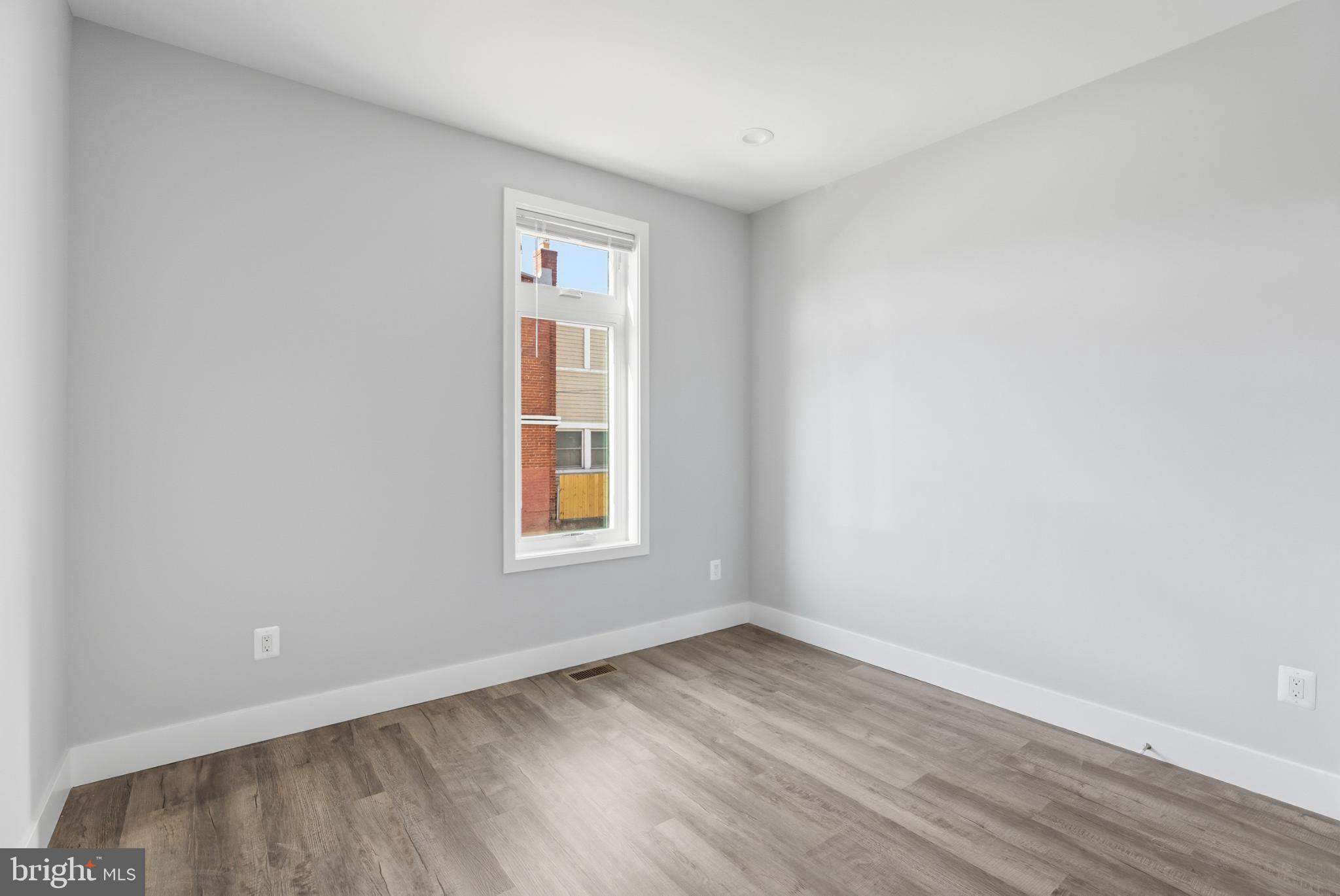 2600 4th Street Northeast, Unit A Washington, DC 20002 - Photo 14 of 33 an empty room with wooden floor and windows
