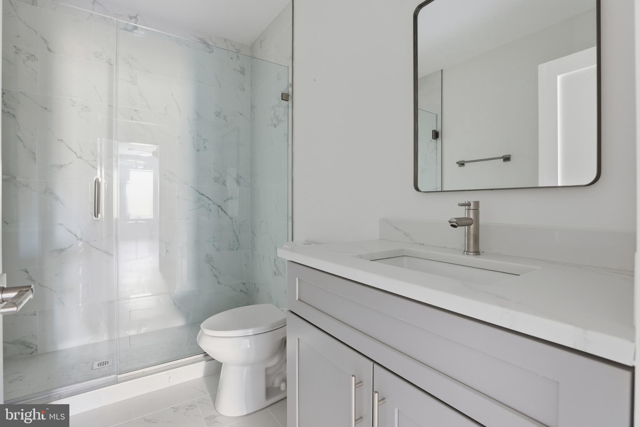 2600 4th Street Northeast, Unit A Washington, DC 20002 - Photo 24 of 33 a bathroom with a sink a toilet and a mirror