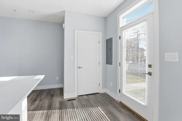 a view of a room with wooden floor and windows